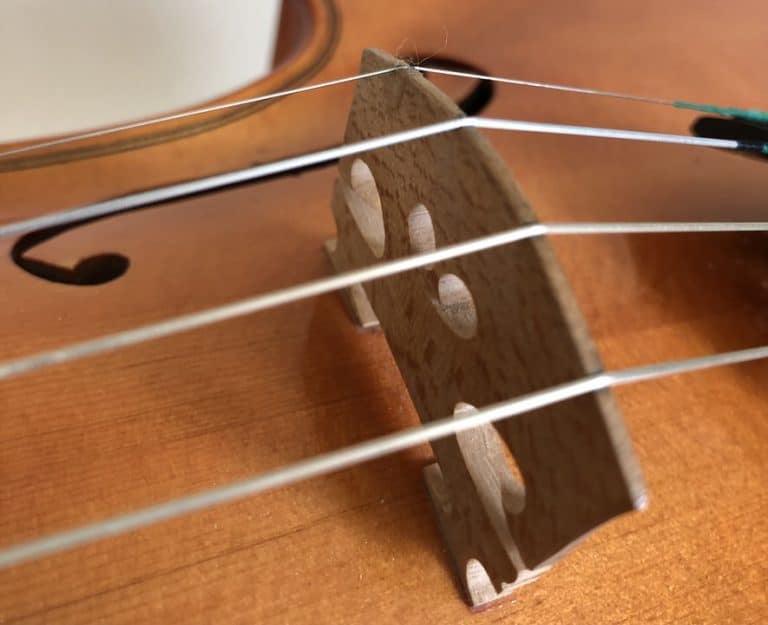Where to Place the Bridge on a Violin? Don’t break the table!